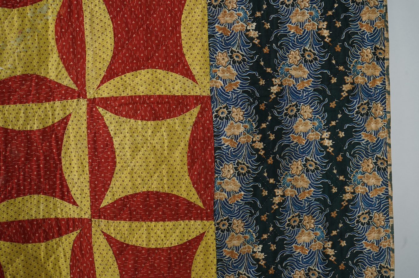 An early 1900’s American, possibly Pennsylvanian ‘robbing Peter to pay Paul’ quilt. Made with brick red and complimentary yellow tiny spot floral printed cotton. With a wide older chintz cotton border and block printed c